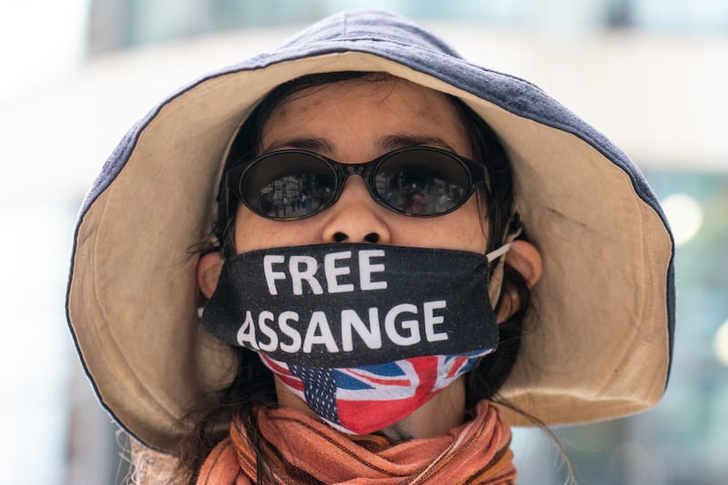 Supporters of WikiLeaks founder Julian Assange protest outside the Home Office in London with campaigners, to mark his birthday