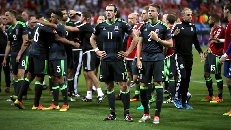 Wales' Gareth Bale (left) and Chris Gunter stand dejected as the players acknowledge the fans after the UEFA Euro 2016 defeat by Portugal&nbsp;