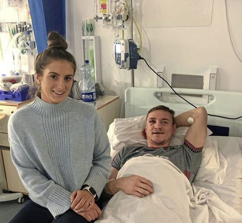Caolan Mooney pictured in hospital with his fiancee Adair Trainor by his side 
