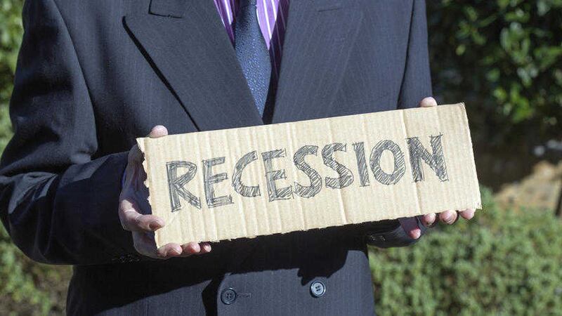 Man holding placard about recession 