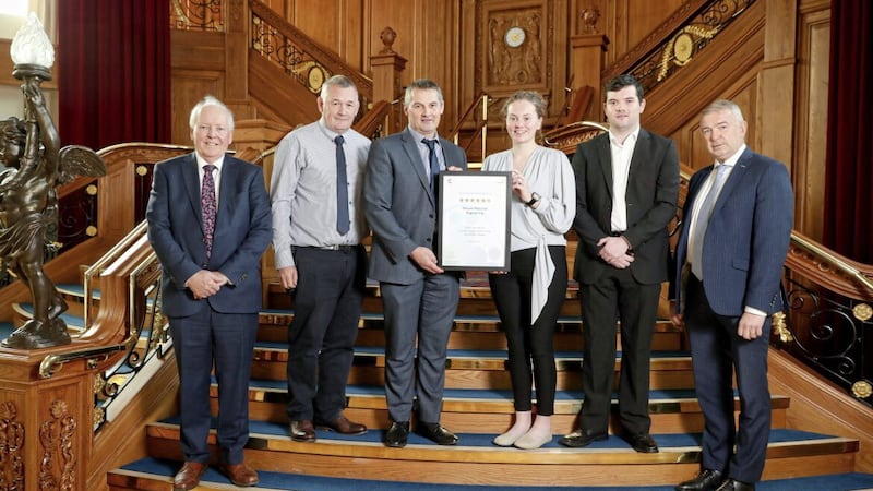 Moyola Precision Engineering&#39;s Peter Donnelly (sales and technical director), Enda Lagan (chief operating officer), Claudia Graffin (HR manager) and Mark Daly (quality engineer) receive their EFQM six star accolade in Titanic Belfast in March, watched by Bob Barbour (CforC director and chief executive) and Randal Gilbert (head of network strategy at NIE Networks) 