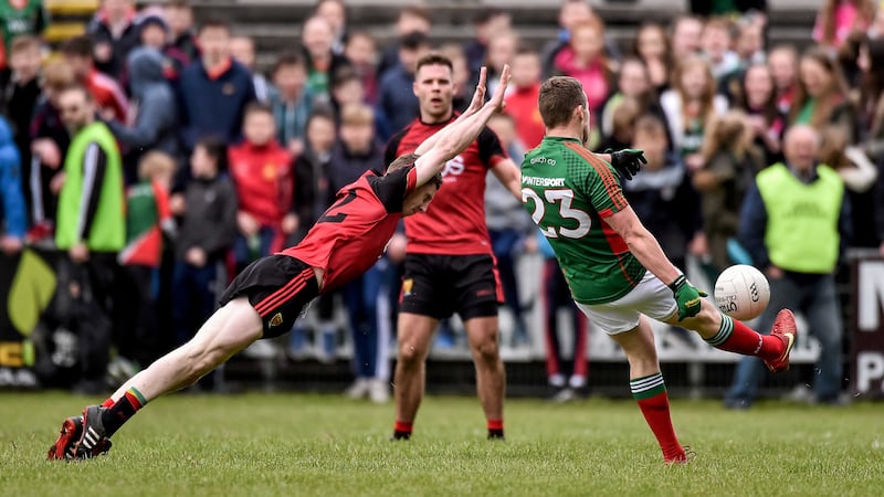 <address><span style=" line-height: 20.8px;">Andy Moran scores a late point for Mayo despite the best efforts of Down&rsquo;s Paul Devlin in Sunday&rsquo;s NFL Division One clash at Elverys MacHale Park in Castlebar<br />Picture by Sportsfile</span>