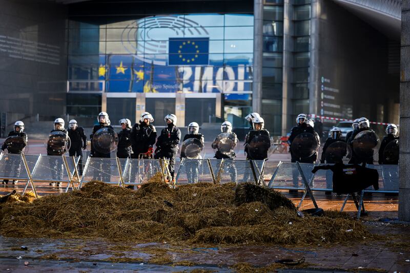 Anti-riot police officers stand guard in a closed security area outside the European Parliament (Thomas Padilla/AP)
