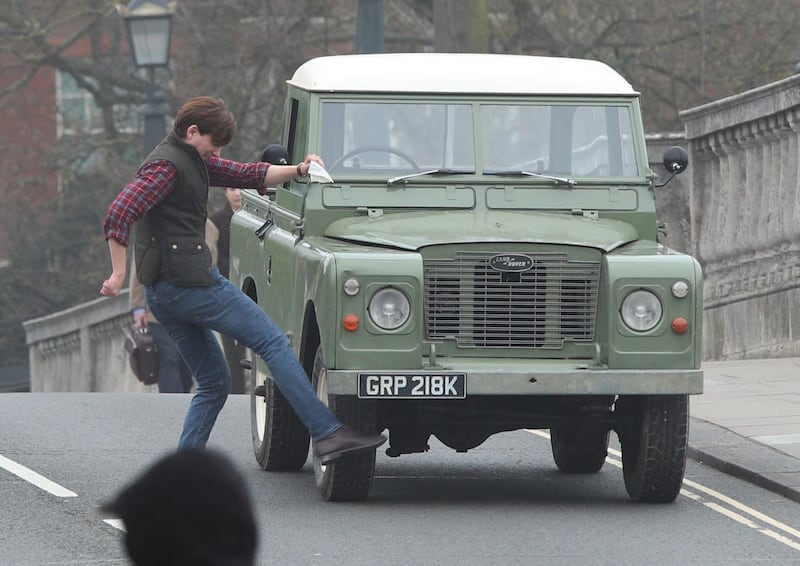 Domhnall Gleeson kicking a car during filming