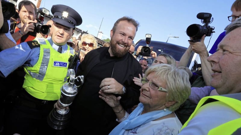 Shane Lowry with his grandmother Emily Scanlon and the Claret Jug during the homecoming event at Clara GAA, Clara in County Offaly 