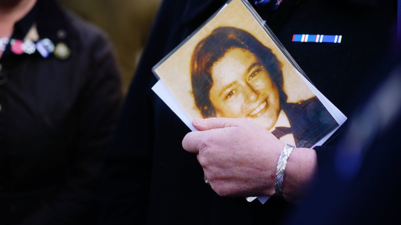 An attendee holds photograph of Pc Yvonne Fletcher during a 40th anniversary memorial service in St James’s Square, London