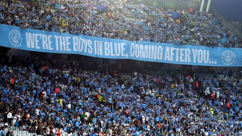 The Manchester City fans in the stands (Martin Rickett/PA)