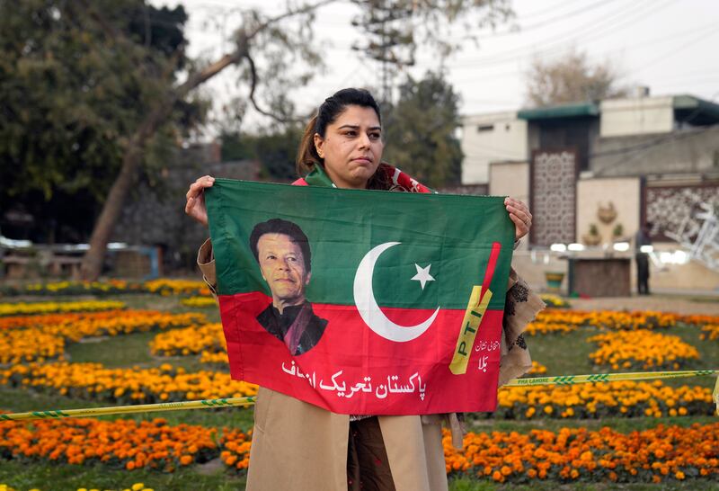A supporter of former prime minister Imran Khan attends an election rally in Lahore (AP Photo/K.M. Chaudary)