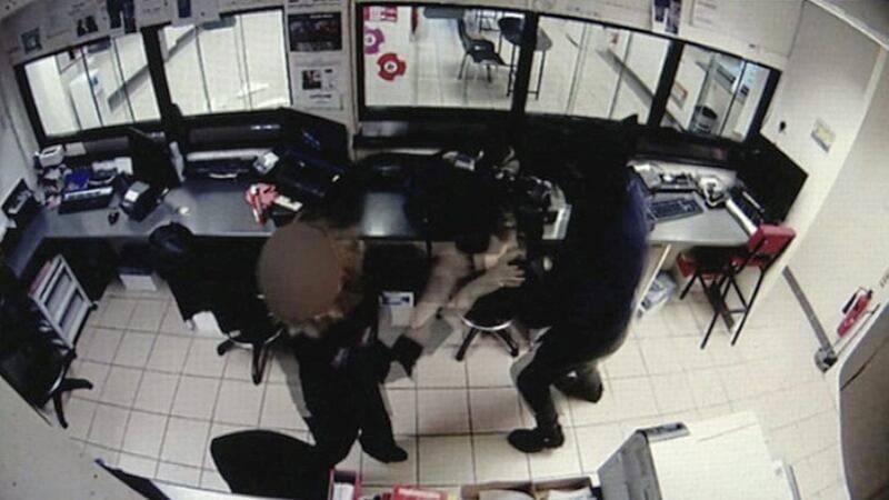 CCTV footage shows the McLean Bookmakers employee being attacked by a robber armed with a stun gun. Picture from UTV 