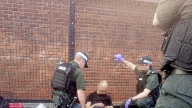 Police assist a man who collapsed near a play park in north Belfast after allegedly injecting heroin 