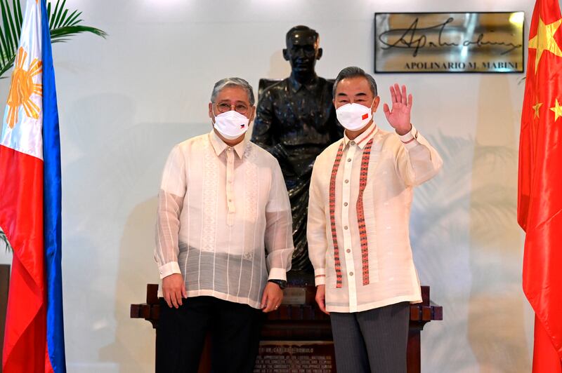 Philippine foreign affairs secretary Enrique Manalo, left, and Chinese foreign minister Wang Yi before their bilateral talks in Manila, Philippines in 2022 (Jam Sta Rosa/Pool Photo via AP)
