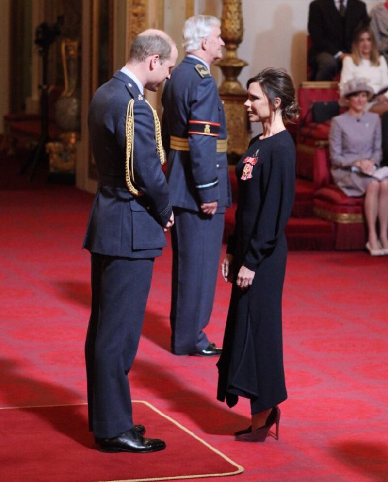 Victoria Beckham receives her OBE from the Duke of Cambridge