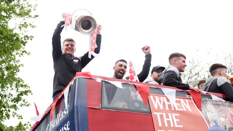 Cliftonville Players celebrate with the fans during an open top bus tour across Belfast after winning the Irish Cup oat Windsor on Saturday.
PIC COLM LENAGAN