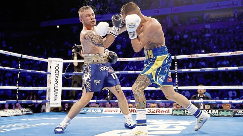 Josh Warrington (right) and Carl Frampton in action in the World Featherweight Championship at Manchester Arena Picture by Martin Rickett/PA Wire 