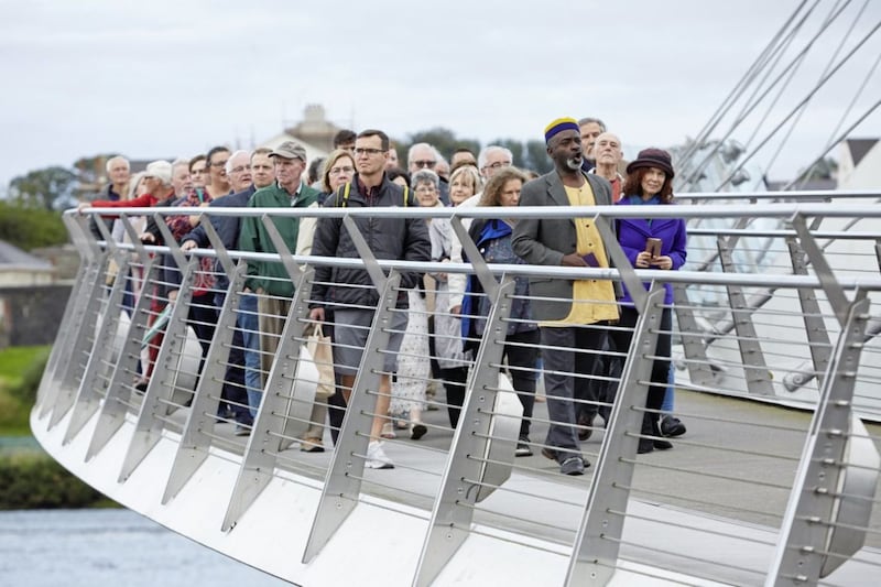 The audience for Freedom of The City were taken on a pre-performance walk across Derry&#39;s Peace Bridge led by spirituals singer Tayo Aluko during Lughnasa FrielFest. Picture by Matthew Andrews 