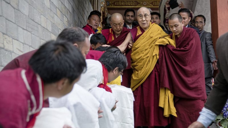 Tibetan spiritual leader the Dalai Lama, centre, returns after teachings at the Thupsung Dhargyeling Monastery in Dirang, Arunachal Pradesh, India on Thursday PICTURE: Tenzin Choejor/AP 