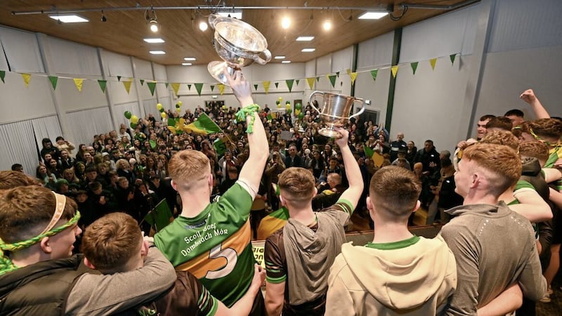 The footballers of St Joseph&#39;s Grammar School, Donaghmore hold aloft the Paddy Drummond and MacLarnon Cups in front of a packed assembly hall of fellow pupils and supporters at a homecoming reception following victory in the All-Ireland Senior &#39;B&#39; Football Championship on Saturday. Picture by Oliver McVeigh 