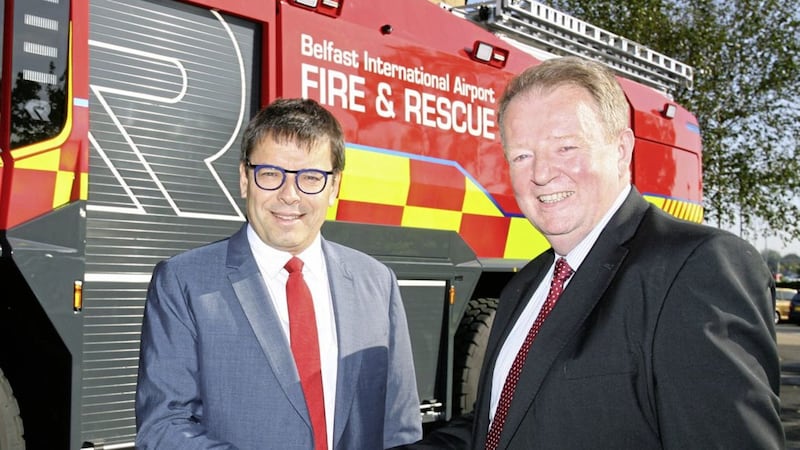 Belfast International Airport managing director Graham Keddie greets Nicolas Notebaert, chief executive of Vinci Concessions and president of Vinci Airports in front of one of the new fire appliances in which the airport has invested &pound;2 million 