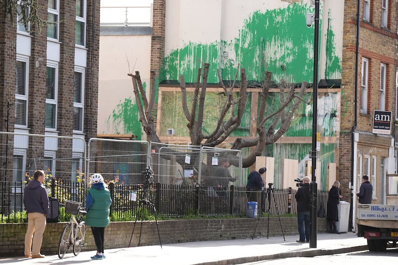 Fencing and plastic sheeting have been put up next to the Banksy artwork in Hornsey Road, Finsbury Park, after it was defaced with white paint last week