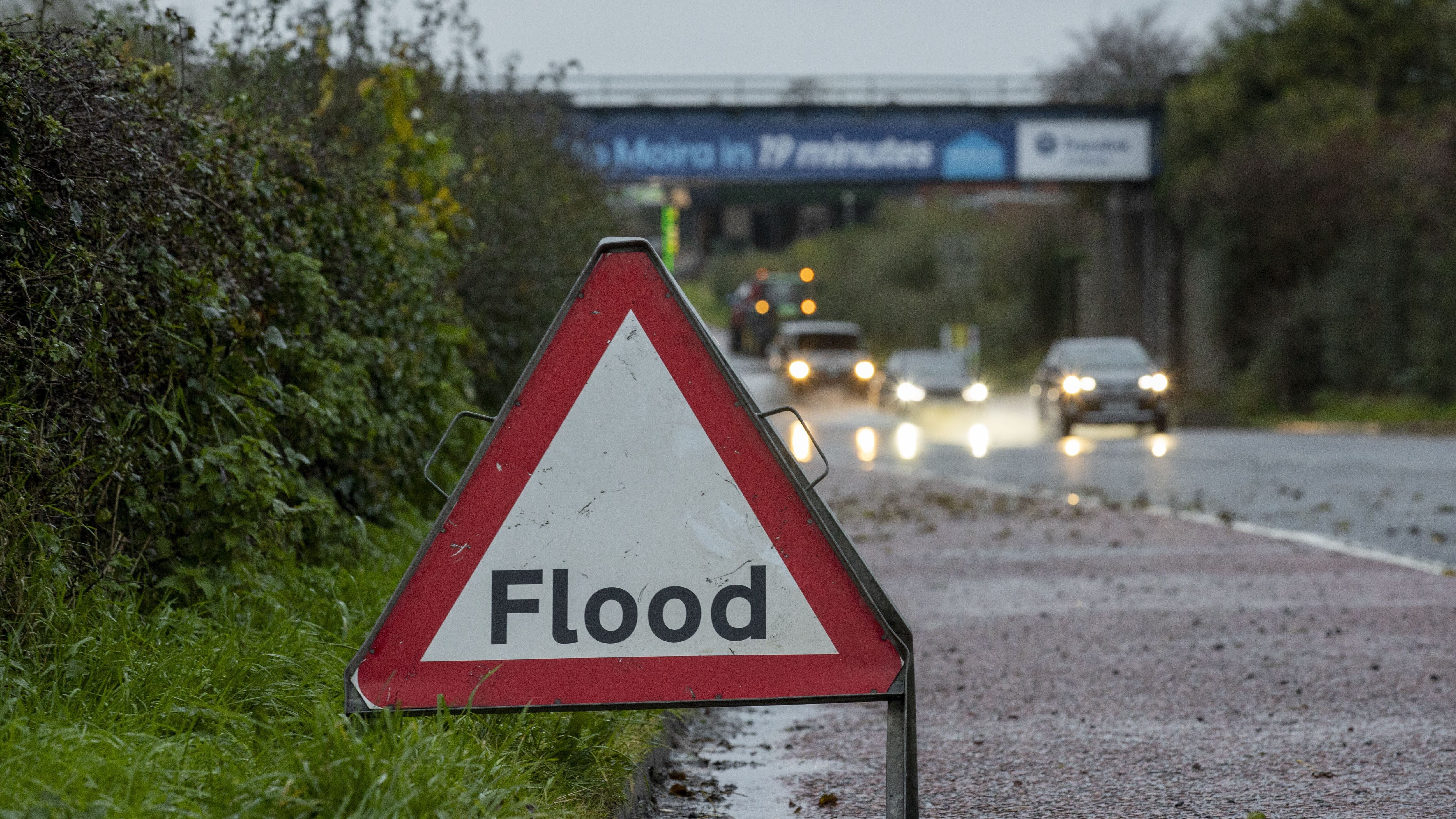 A road sign advising drivers of flooding on the A26 outside Moira in Northern Ireland (Liam McBurney/PA)
