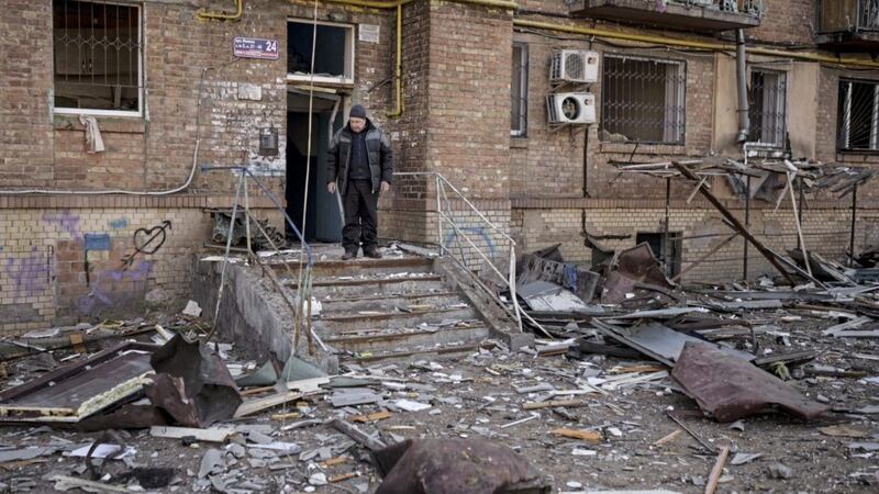 A resident stands at the entrance of his building, damaged after bombing in Kyiv, Ukraine. Picture by Felipe Dana, Associated Press 