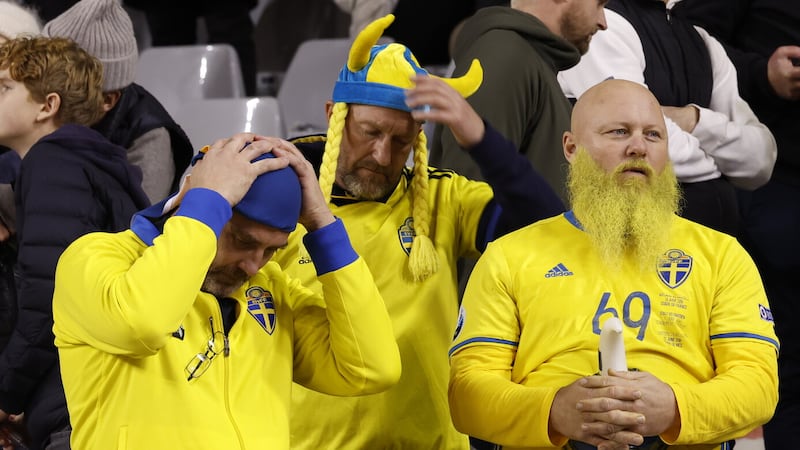 Sweden supporters wait in the stands after the suspension of the Euro 2024 group F qualifying match (Geert Vanden Wijngaert/AP)
