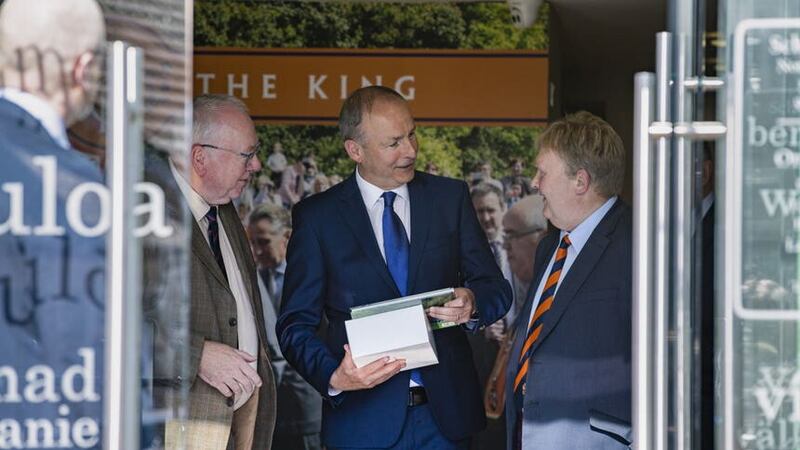Tanaiste Micheal Martin (centre) leaving the Museum of Orange Heritage in Belfast with gifts after a guided tour by Orange Order Grand Secretary Mervyn Gibson and Deputy Grand MasterHarold Henning, after meeting with some of Stormont’s main political parties earlier on Wednesday (Liam McBurney/PA)