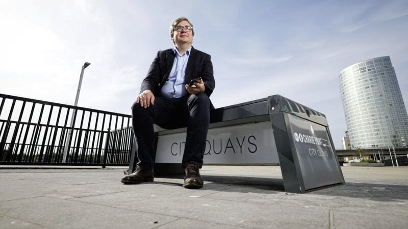 Flowlens chief executive Rich Dale pictured with the &#39;Stellar&#39; solar charging bench which is manufactured by Flowlens customer Environmental Street Furniture. Photo: Kelvin Boyes/PressEye 