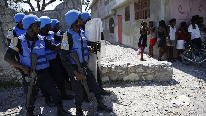 UN peacekeepers from Senegal stand guard outside a UN base as troops clash with rock-throwing neighborhood residents in Les Cayes, Haiti. Picture by Rebecca Blackwell, Associated Press