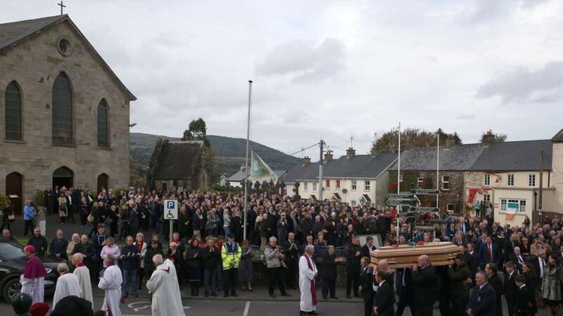 Mourners look on as the coffin carrying the remains of Anthony Foley leaves St Flannan's Church, Killaloe, Co Clare. Picture by Brian Lawless, Press Association