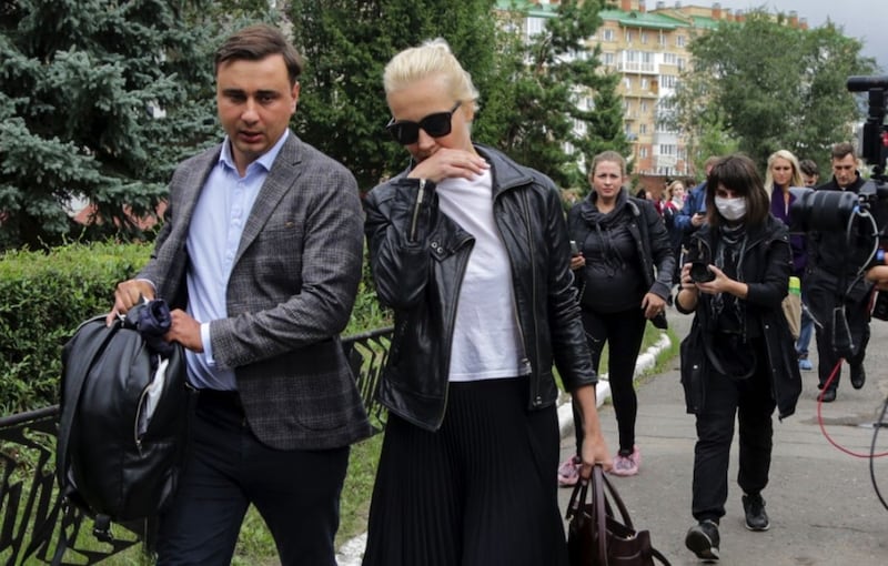 Alexei Navalny's wife Yulia, centre, and Navalny's colleague Ivan Zhdanov, left, arrive at a hospital in Omsk, Russia. Picture by Evgeniy Sofiychuk, Associated Press