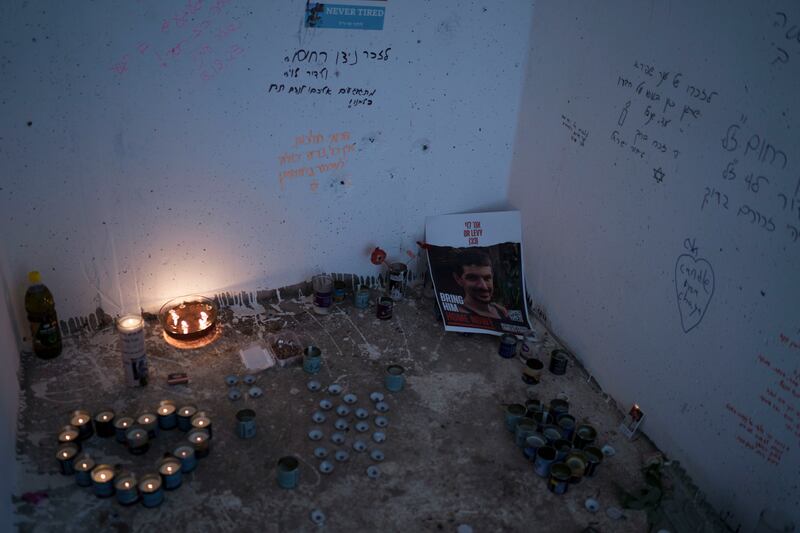 Lighted candles are seen in a roadside bomb shelter where people were killed during the Hamas militants attack near the Israeli-Gaza border (AP)