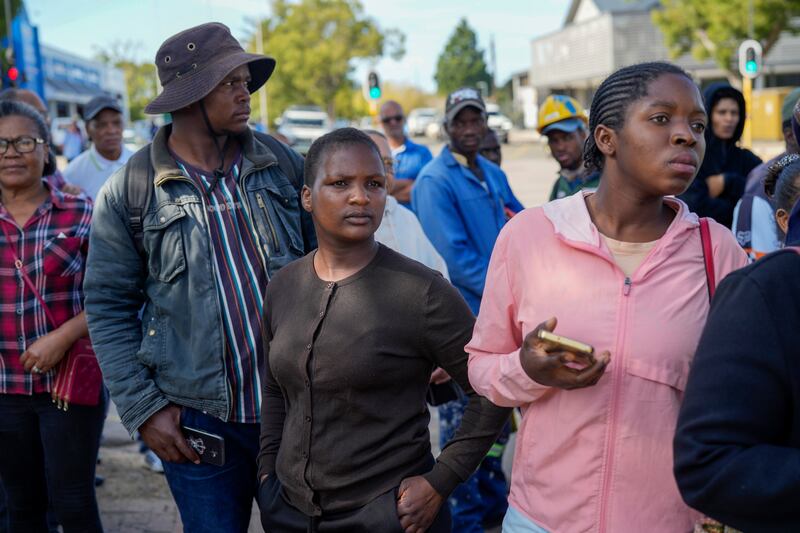 Onlookers gather near the site of the building collapse in George, South Africa (Jerome Delay/AP)