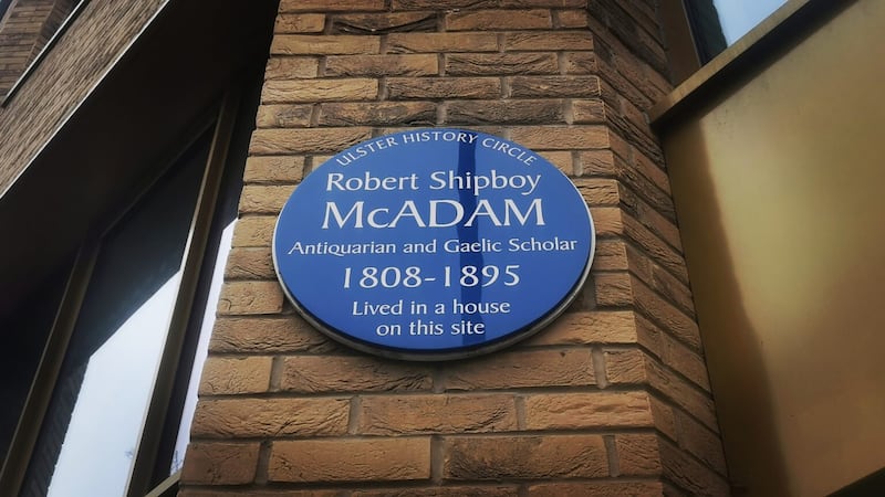 The blue plaque honouring Robert Shipboy McAdam at his former home which today is known as Stokes House in College Square East