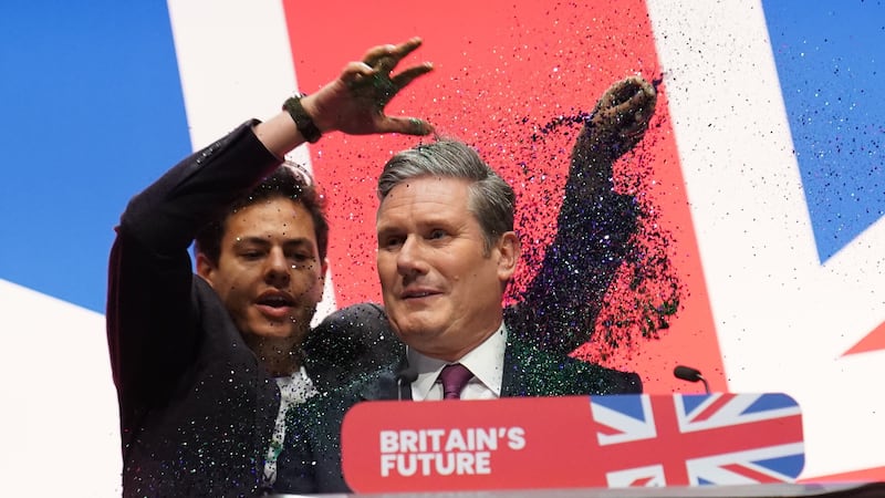 A protester throws glitter over Labour leader Sir Keir Starmer (Stefan Rousseau/PA)