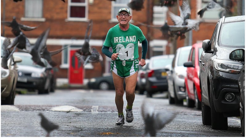 The award=winning picture of Francie Arthurs running through the streets of west Belfast. Picture by Mal McCann