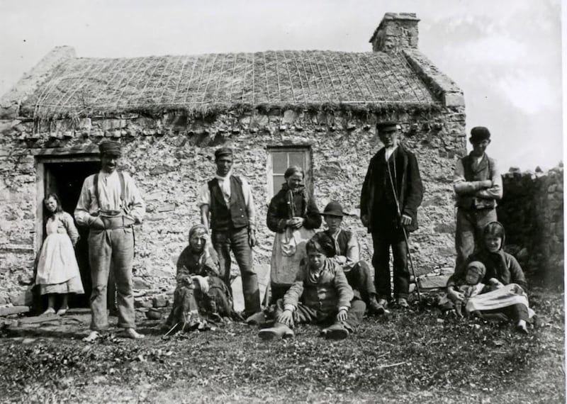 Natives of Gweedore, Donegal outside their thatched smallholding 