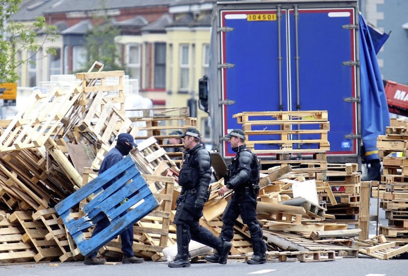 Police and contractors move into Cluan Place in east Belfast to remove a loyalist bonfire from the road Picture Mal McCann. 