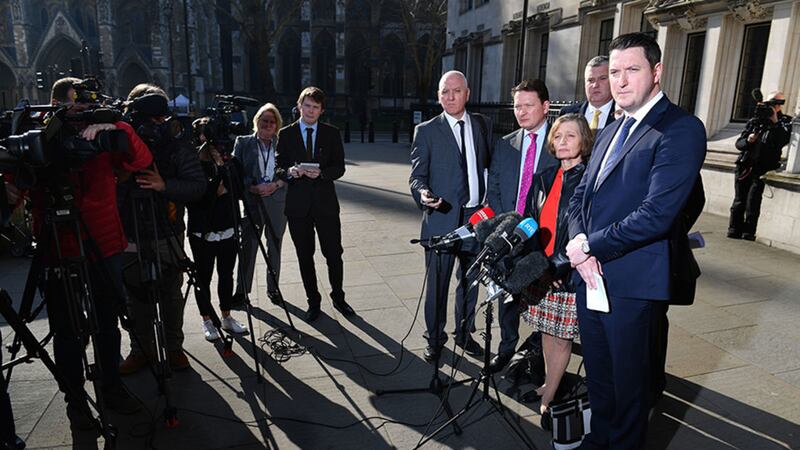 Geraldine Finucane, the widow of murdered Belfast solicitor Pat Finucane, accompanied by her sons John (right) and Michael (second left) speaks with reporters outside the Supreme Court in central London