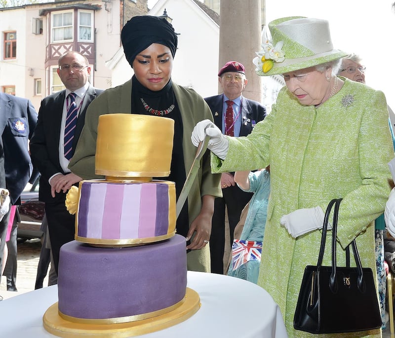 Queen Elizabeth II with Nadiya Hussain, winner of the Great British Bake Off who baked a cake for her, during a walkabout close to Windsor Castle in Berkshire as she celebrates her 90th birthday