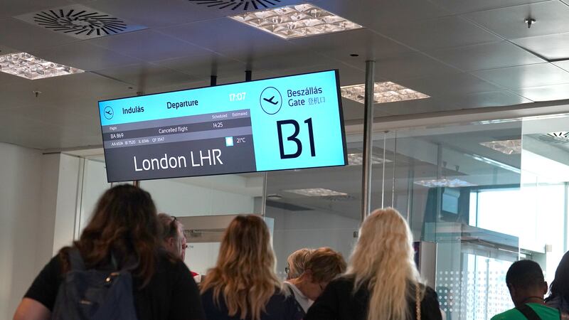 Passengers wait at a departure gate at Ferenc Liszt International Airport in Budapest, Hungary, as flights to the UK and Ireland have been cancelled as a result of air traffic control issues in the UK