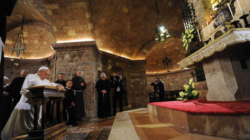 Pope Francis prays at the tomb of St Francis during his visit to Assisi in 2013. St Francis&#39;s enjoinder to preach the Gospel always and use words if necessary remains true today, says Fr Dominic McGrattan 