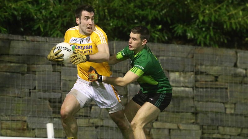 Antrim's Kevin Niblock gets away from QUB's Greg McCabe.&nbsp;Picture by Hugh Russell&nbsp;