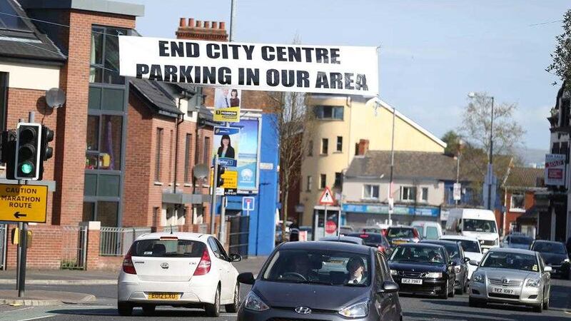 Cars pass the `End City Centre Parking in Our Area&#39; banner on the Ravenhill Road in south Belfast. Picture by Hugh Russell 