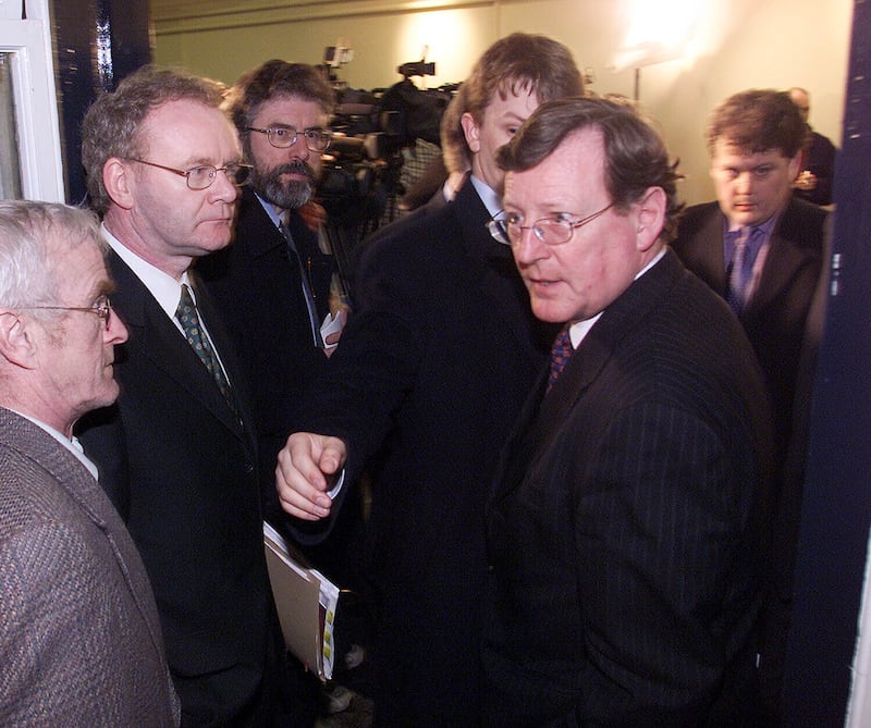 Ulster Unionist Leader David Trimble (right) is ushered past Sinn Fein Leader Gerry Adams (3rd left) and Martin McGuinness (2nd left), after talks broke up at Hillsborough Castle.