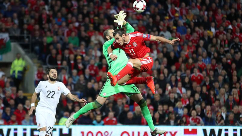Wales' Gareth Bale and Georgia goalkeeper Giorgi Loria battle for the ball during Sunday's Fifa World Cup qualifier at the Cardiff City Stadium<br />Picture by PA