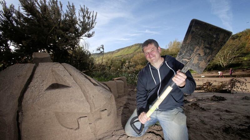 Andrew Difford with one of the sand pumpkins he created as part of a pumpkin challenge on Waterfoot Beach, Co Antrim. Picture by Mal McCann 