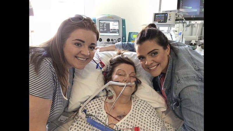 Maggie Hesketh pictured in hospital on her 64th birthday with her daughters, Mairead (left) and Maeve (right) 