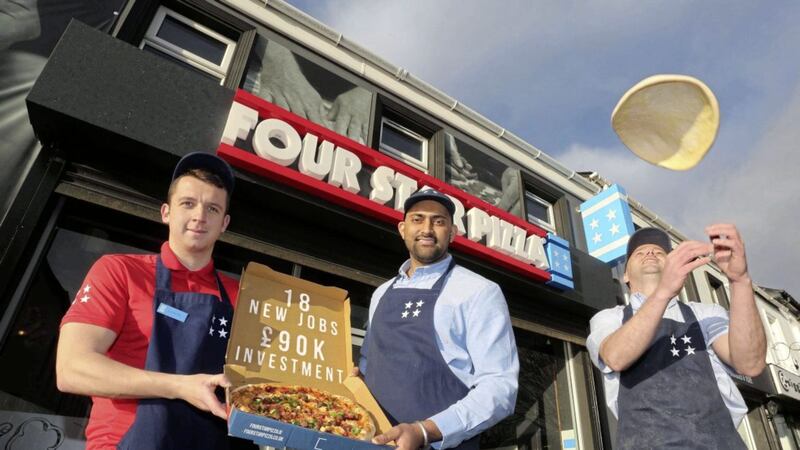 Bobby Singh (centre), owner of the new Coleraine Four Star Pizza store, is joined by team members Jad Dorrian (left) and Rui Pedro Ribeiro (right) to celebrate the opening of the store. 