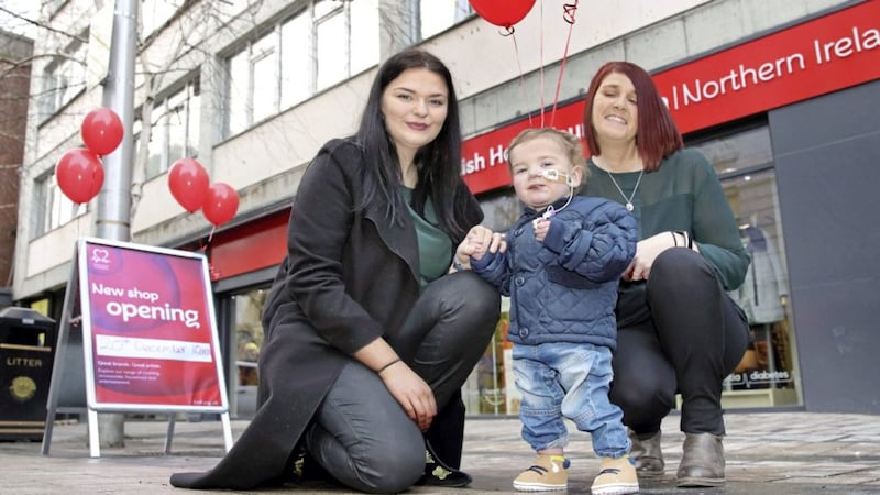 D&aacute;ith&iacute; Mac Gabhann (2) helped open the British Heart Foundation pop-up shop in Fountain Street. He is pictured with mum Seph Ni Mheallain, left, and store manager Louise Cardwell. Picture by Cliff Donaldson 